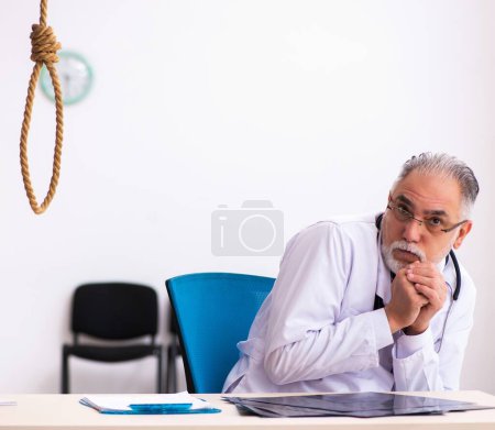 Photo for Old doctor committing suicide at workplace - Royalty Free Image