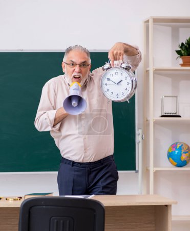 Photo for Old senior teacher in time management concept - Royalty Free Image