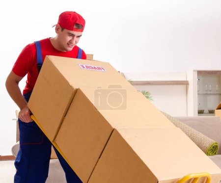 Photo for The young contractor with boxes working indoors - Royalty Free Image