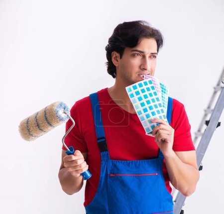 Photo for The young handsome contractor working indoors - Royalty Free Image