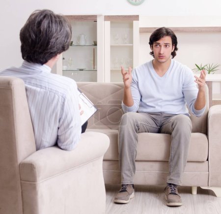 Photo for Young male patient discussing with psychologist personal problems - Royalty Free Image