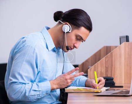 Photo for The call center operator working at his desk - Royalty Free Image