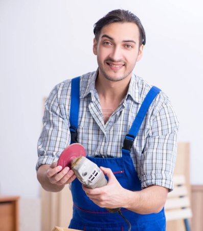 Photo for The young male carpenter working indoors - Royalty Free Image