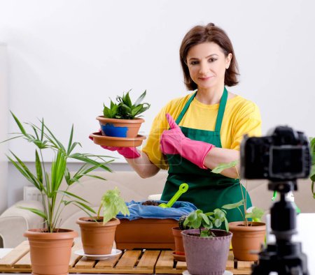 Photo for The female blogger explaining houseplants growing - Royalty Free Image