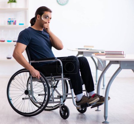 Photo for Young student in wheel-chair preparing for exams - Royalty Free Image