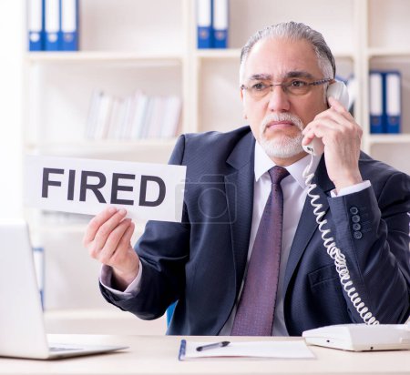 Photo for White bearded old businessman employee unhappy with excessive work - Royalty Free Image