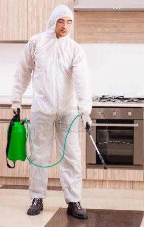 Photo for The professional contractor doing pest control at kitchen - Royalty Free Image