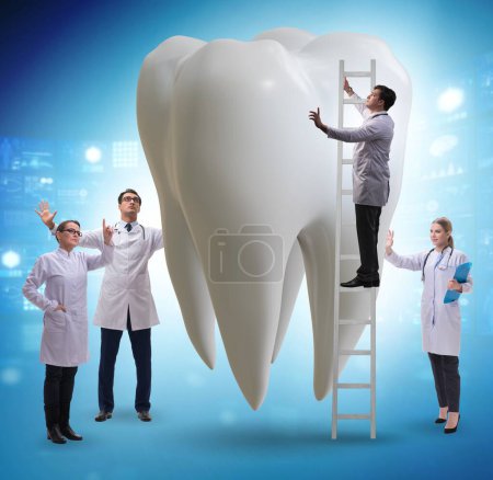 Photo for The doctors examining giant tooth in dental concept - Royalty Free Image