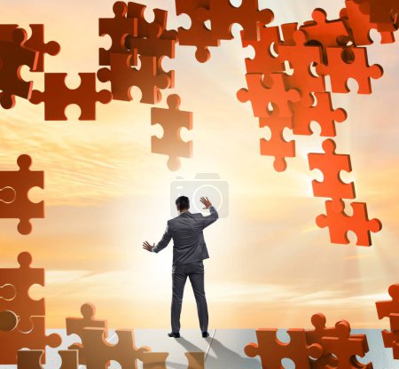 Photo for Businessman breaking wall of jigsaw puzzle - Royalty Free Image