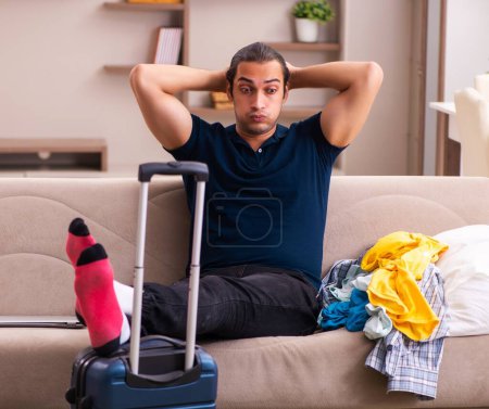 Photo for Young man preparing for trip at home - Royalty Free Image