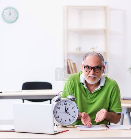 Photo for Senior male student in time management concept - Royalty Free Image