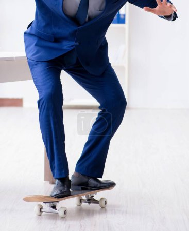 Photo for The young businessman with skate in office in sports concept - Royalty Free Image