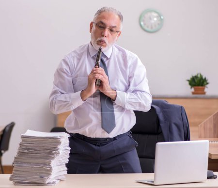 Photo for Old employee being desperate with excessive work in the office - Royalty Free Image