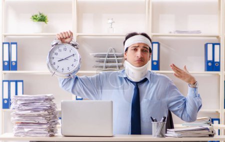 Photo for The young injured male employee working in the office - Royalty Free Image