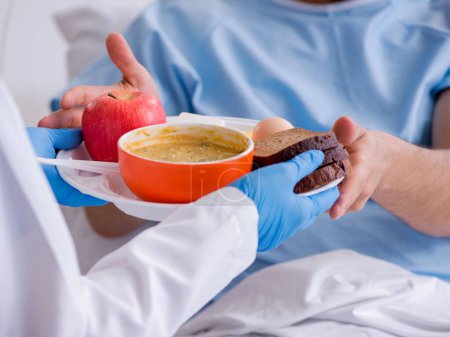 Photo for The male patient eating food in the hospital - Royalty Free Image