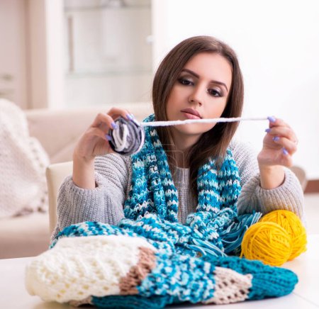 Photo for The young beautiful woman knitting at home - Royalty Free Image
