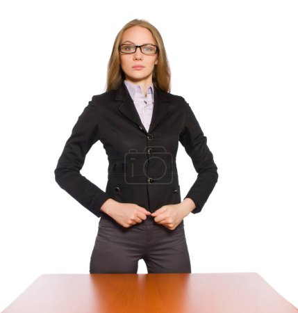 Foto de La empleada sentada en la mesa larga aislada en blanco - Imagen libre de derechos