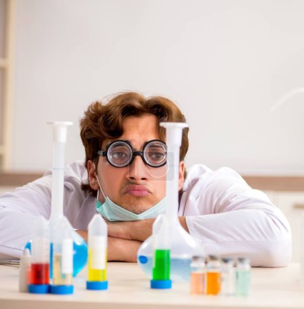 Photo for The funny crazy chemist doing experiments and tests - Royalty Free Image