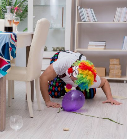 Photo for The drunk clown celebrating having a party at home - Royalty Free Image