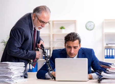 Téléchargez les photos : Le vieux patron et jeune employé masculin dans le bureau - en image libre de droit