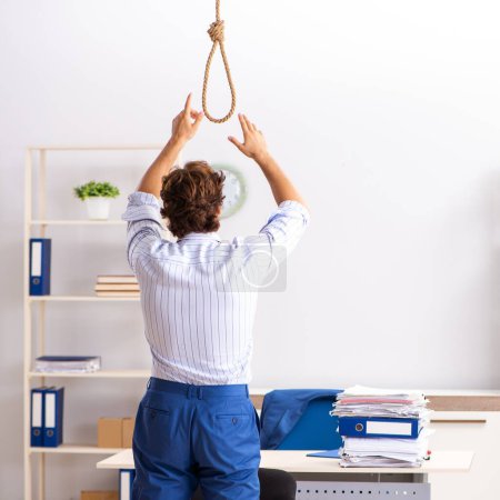 Photo for The desperate businessman thinking of committing suicide hanging - Royalty Free Image
