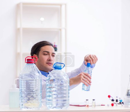 Photo for The young male chemist experimenting in lab - Royalty Free Image