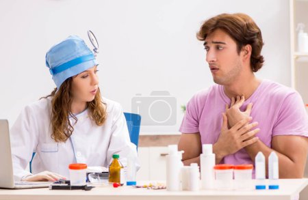 Photo for The young handsome man visiting young female doctor otolaryngologist - Royalty Free Image