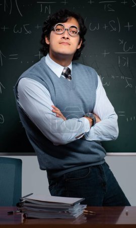 Photo for The young math teacher in front of chalkboard - Royalty Free Image