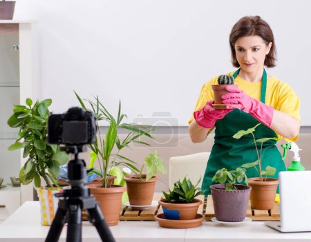 Photo for The female blogger explaining houseplants growing - Royalty Free Image