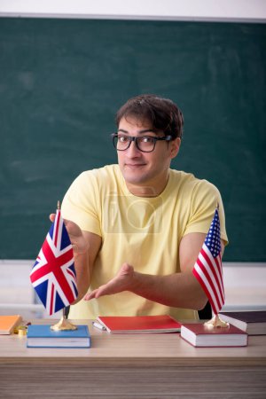 Photo for Young English language teacher sitting in the classroom - Royalty Free Image