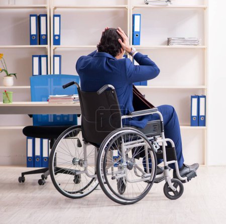 Photo for The young male employee in wheelchair working in the office - Royalty Free Image