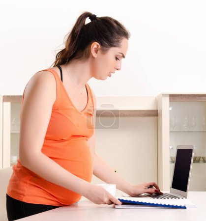 Photo for The young pregnant woman working at home - Royalty Free Image