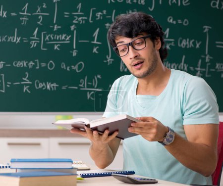 Photo for The young male student mathematician in front of chalkboard - Royalty Free Image