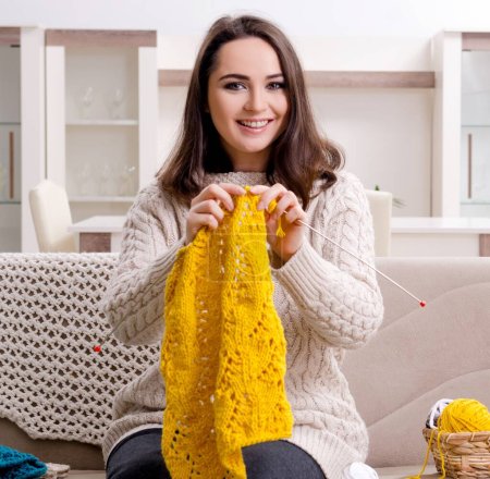 Téléchargez les photos : La jeune belle femme tricote à la maison - en image libre de droit