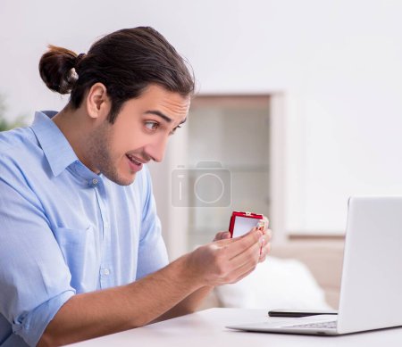 Photo for Man doing marriage proposal via Internet - Royalty Free Image