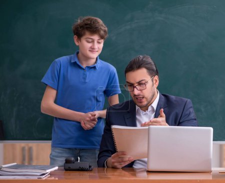 Photo for Male teacher and schoolboy in the classroom - Royalty Free Image