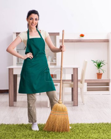 Photo for The young female contractor doing housework - Royalty Free Image