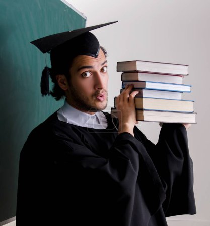 Photo for The graduate student in front of green board - Royalty Free Image