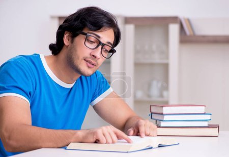 Photo for The young handsome student studying at home - Royalty Free Image