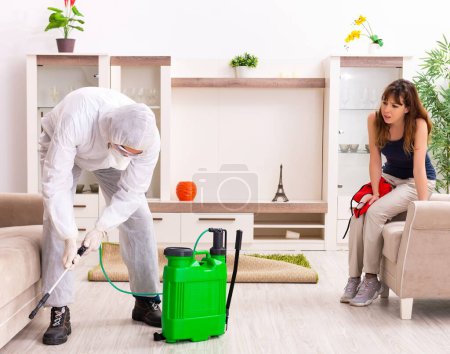 Photo for The young professional contractor doing pest control at flat - Royalty Free Image
