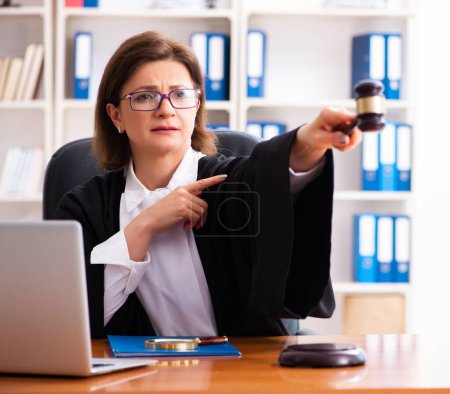 Photo for The middle-aged female doctor working in courthouse - Royalty Free Image