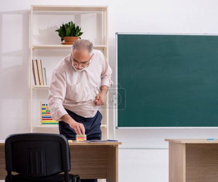 Photo for Old teacher in front of blackboard - Royalty Free Image