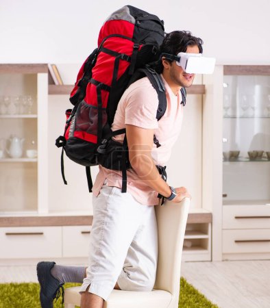 Foto de The young male tourist with virtual glasses preparing for trip - Imagen libre de derechos