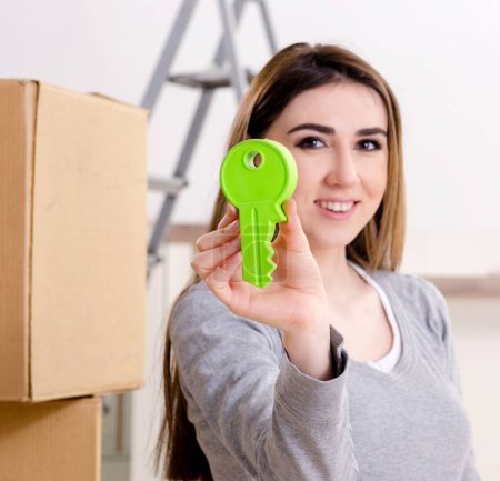 Photo for The young beautiful woman moving to new flat - Royalty Free Image