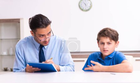 Photo for The busy father helping his son to prepare for exam - Royalty Free Image