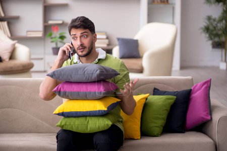Photo for Young man with a lot of pillows at home - Royalty Free Image