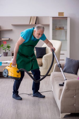 Photo for Old contractor cleaning the house - Royalty Free Image