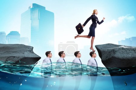 Photo for Inequal competition concept with the businesswoman walking on heads - Royalty Free Image
