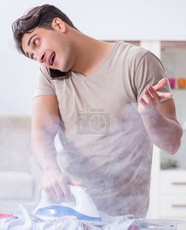 Photo for The inattentive husband burning clothing while ironing - Royalty Free Image