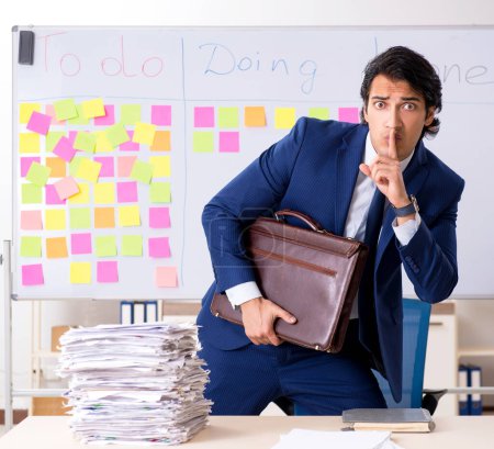 Photo for The young handsome employee in front of whiteboard with to-do list - Royalty Free Image